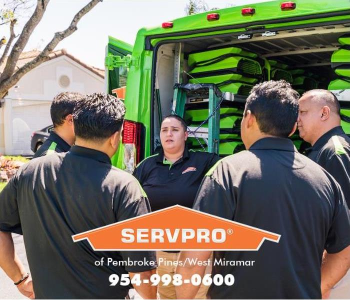 A team of SERVPRO technicians are getting their assignments for a property that was vandalized.