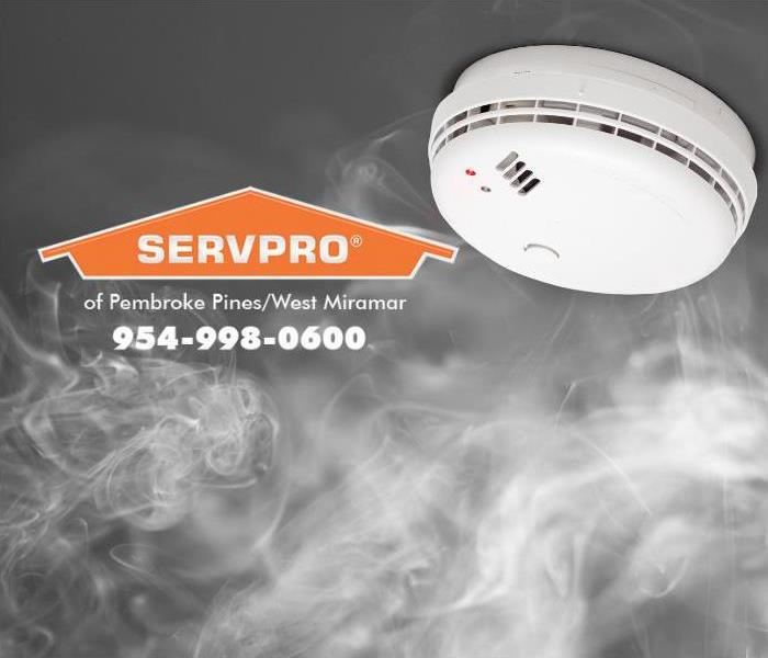 Smoke is shown rising up towards a smoke alarm installed on the ceiling. 