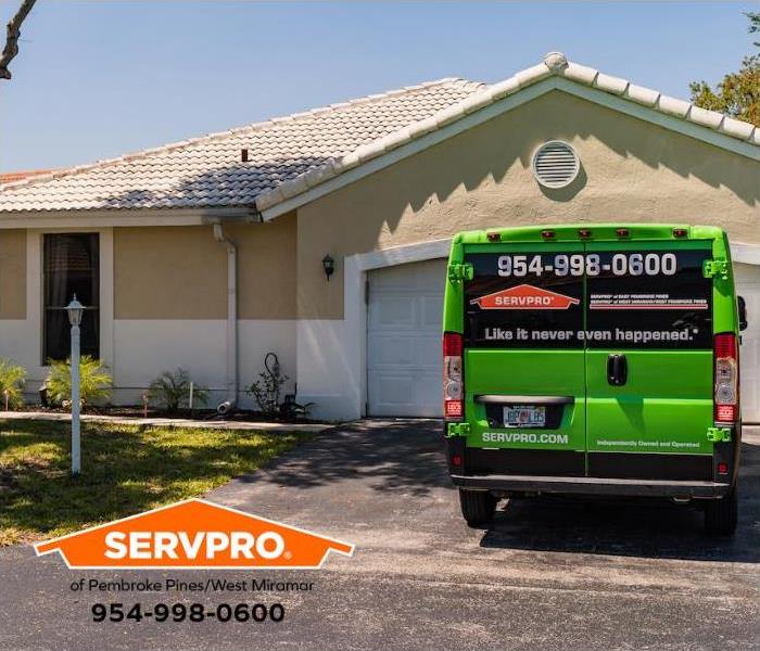 A SERVPRO® of Pembroke Pines/West Miramar service van sits outside a home.